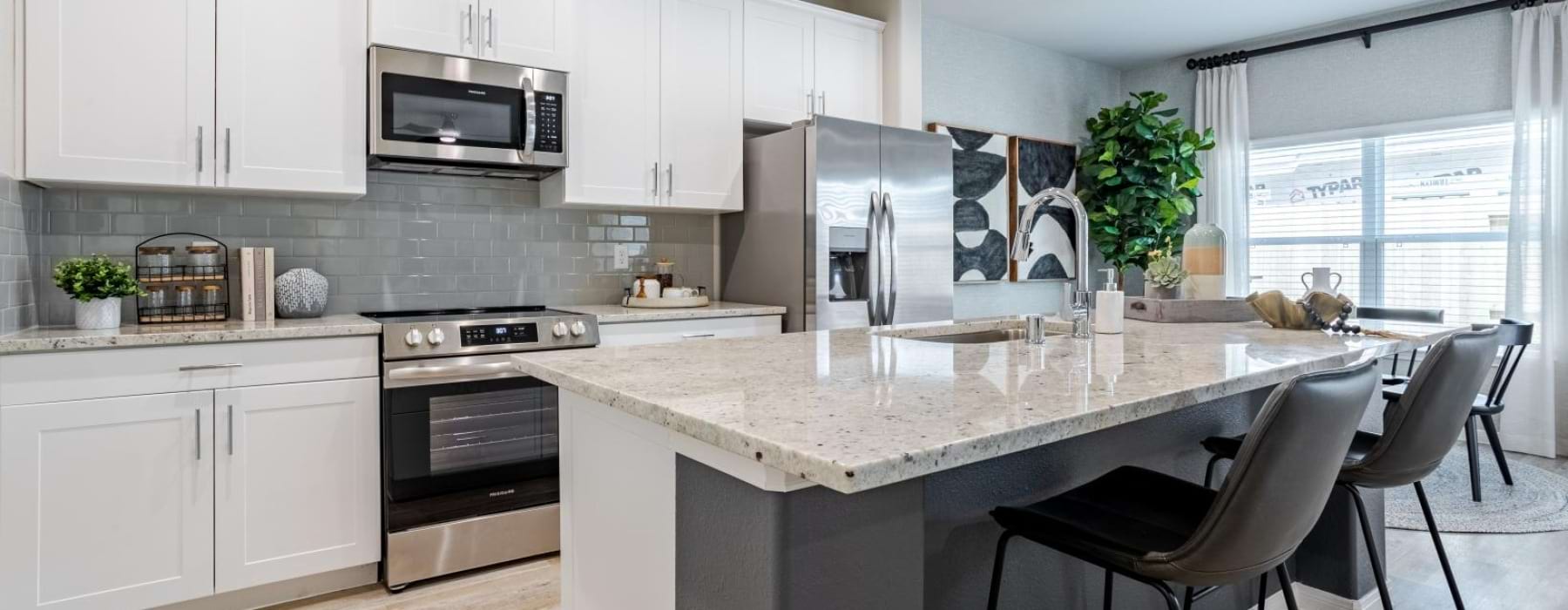 a kitchen with white cabinets