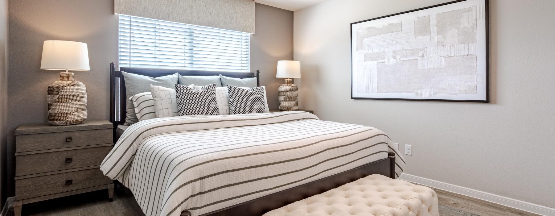 a bedroom with a bed and lamps