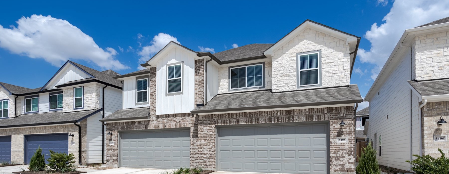 a row of houses with garages
