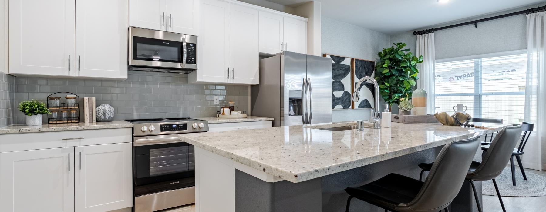 a kitchen with white cabinets